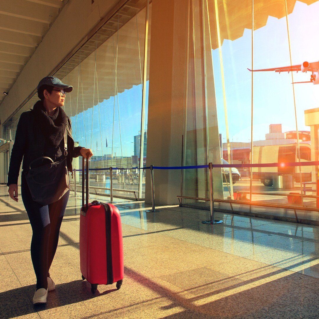 23263036_traveling-woman-and-luggage-walking-in-airport-terminal-and-air-2-1
